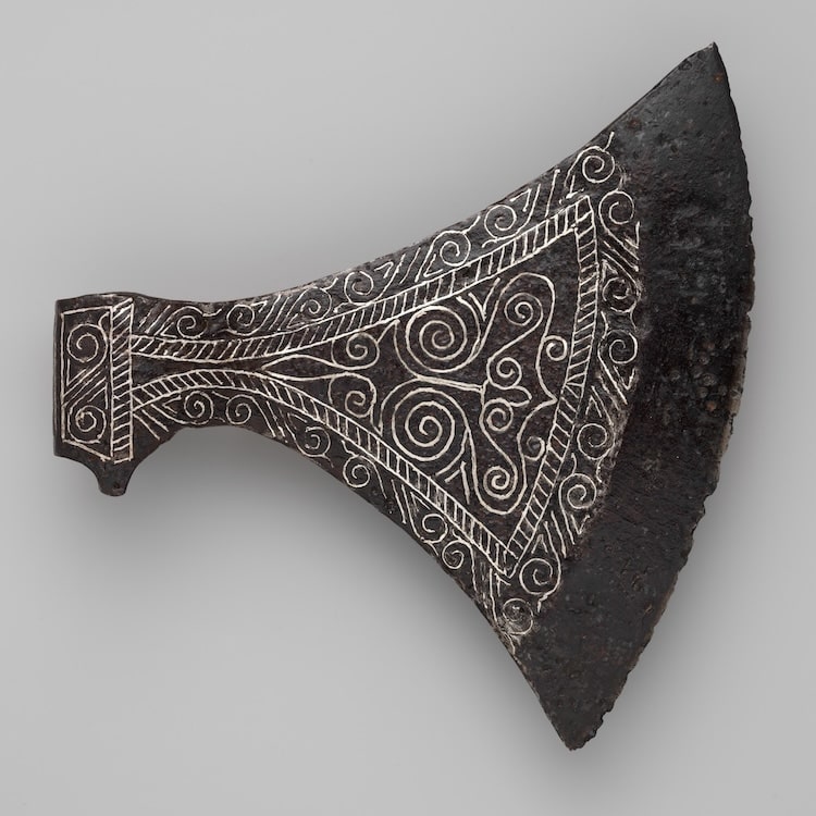 Ax Head. Scandinavian. 11th–12th century. Decorated weapons – swords, axes, spears – were the most highly valued possessions of Viking men, essential as symbols of their rank and status within society, in addition to serving as functional fighting equipment. Metropolitan Museum of New York.